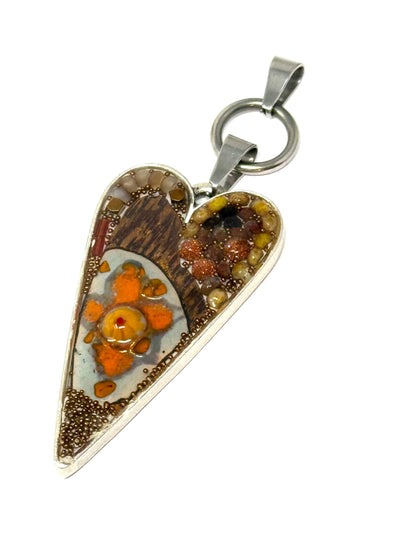 This copper-colored enamel heart pendant necklace features hand-beaded designs in brown and orange with interchangeable options.