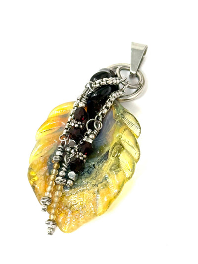 Interchangeable handmade glass leaf focal bead accented with dangling gemstone ruby beads.