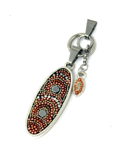 This small oval mosaic pearl pendant is designed with interchangeable orange, green, and silver pearls.