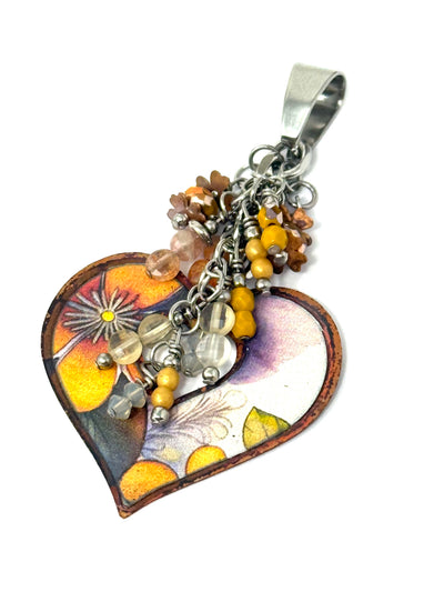 Handmade floral heart copper enamel bead accented with a cluster of beads.