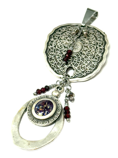 Handmade dangle pendant featuring detailed silver filigree and unique gemstone accents, perfect for stylish accessorizing.