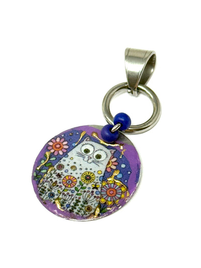 Colorful handmade copper enamel kitty cat pendant with floral design and blue accent, perfect for everyday wear.