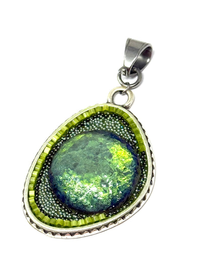 Handmade chunky Czech glass pendant with a vibrant green stone and intricate silver detailing, perfect for unique style.