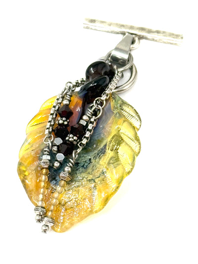 Handmade Lampwork Glass Leaf Interchangeable Pendant with silver detailing and vibrant colors, perfect for stylish necklaces.