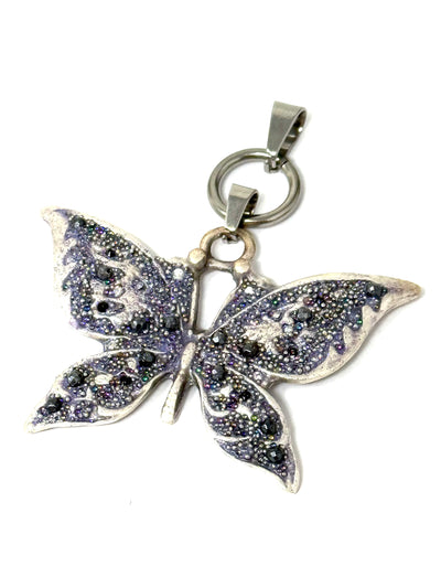 This necklace features a hand-beaded purple butterfly pendant, showcasing intricate beadwork and an elegant shimmer.