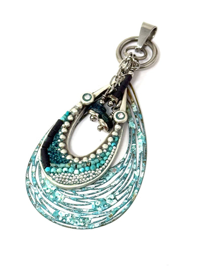 Hand-beaded copper patina pendant with dangling beads. Its unique interchangeable design allows for versatility in styling.